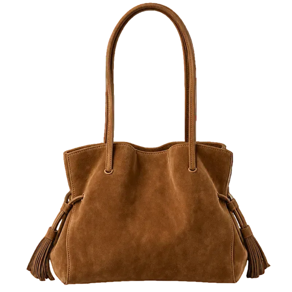 A medium brown suede tote bag with dual shoulder straps and decorative tassels on the sides, photographed against a clean white background.